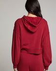 Back view of model wearing Abilenee Blood Red Zip Up Hoodie with cropped hem and full-zip closure against a plain background