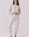 Full body view of woman wearing Chaser’s light grey Tossed Hearts Pants with matching Tossed Hearts Long Sleeve top on a white background