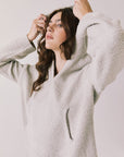 Side view of woman wearing Chaser’s Hazen Heather Grey Pullover Hoodie on a white background