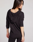 Back view of model wearing 3/4 Sleeve Split Side Licorice Dolman Hoodie in black with dolman sleeves and split-side hem on plain background