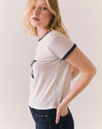 White ringer tee with black star print and vintage-inspired silhouette.