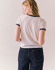 White ringer tee with black star print and vintage-inspired silhouette.