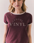 Front view of model in J’adore Vinyl Tee in fig purple with cream ringer trim and vintage-style text