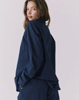 Chaser Paso Navy Button Up in Navy shown from over shoulder back view with fluid drape