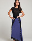 Full front view of model wearing 90’s Licorice Black Baby Tee with scoop neckline and fitted waist paired with a purple skirt with black lace against a plain background
