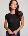 Front view of model wearing 90’s Licorice Black Baby Tee with scoop neckline and fitted waist with a purple skirt with black lace against a plain background
