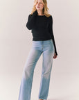 True black fitted ribbed long sleeve top with thumb holes and minimalist silhouette.