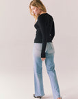 True black fitted ribbed long sleeve top with thumb holes and minimalist silhouette.