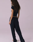 Chaser Sandyy Licorice Black Trouser back walking view with matching Kimpton Licorice Tank showing easy pull on waistband and fluid wide leg movement