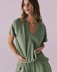 Model wearing the Chaser Cheyenne Meadow Green Pullover featuring a relaxed fit with a split neckline and raw-edge short sleeves
