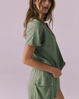 Side view of the Chaser Cheyenne Meadow Green Pullover showing the laid-back drape and ribbed hem detail
