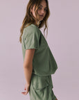 Side view of the Chaser Cheyenne Meadow Green Pullover showing the laid-back drape and ribbed hem detail