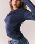 Navy off-the-shoulder long sleeve top with fitted body and sleeves.