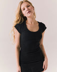 Black ribbed mini dress with scoop neckline, cap sleeves, and a fitted silhouette.