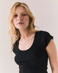 Black ribbed mini dress with scoop neckline, cap sleeves, and a fitted silhouette.