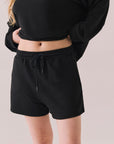 Black drawstring lounge shorts made from soft pillow terry.
