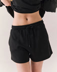 Black drawstring lounge shorts made from soft pillow terry.