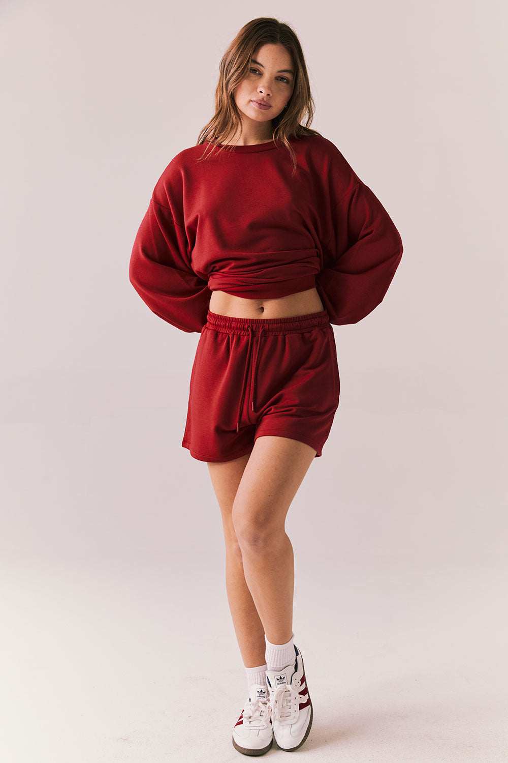 Crimson red drawstring lounge shorts in pillow terry fabric.