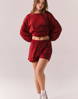 Crimson red drawstring lounge shorts in pillow terry fabric.