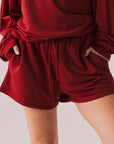 Crimson red drawstring lounge shorts in pillow terry fabric.