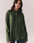 Front view of a model wearing the Helenaa button-down shirt in bronze green with collared neckline and relaxed silhouette, against a plain background.