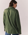 Back view of a model wearing the Helenaa button-down shirt in bronze green with collared neckline and relaxed silhouette, against a plain background.