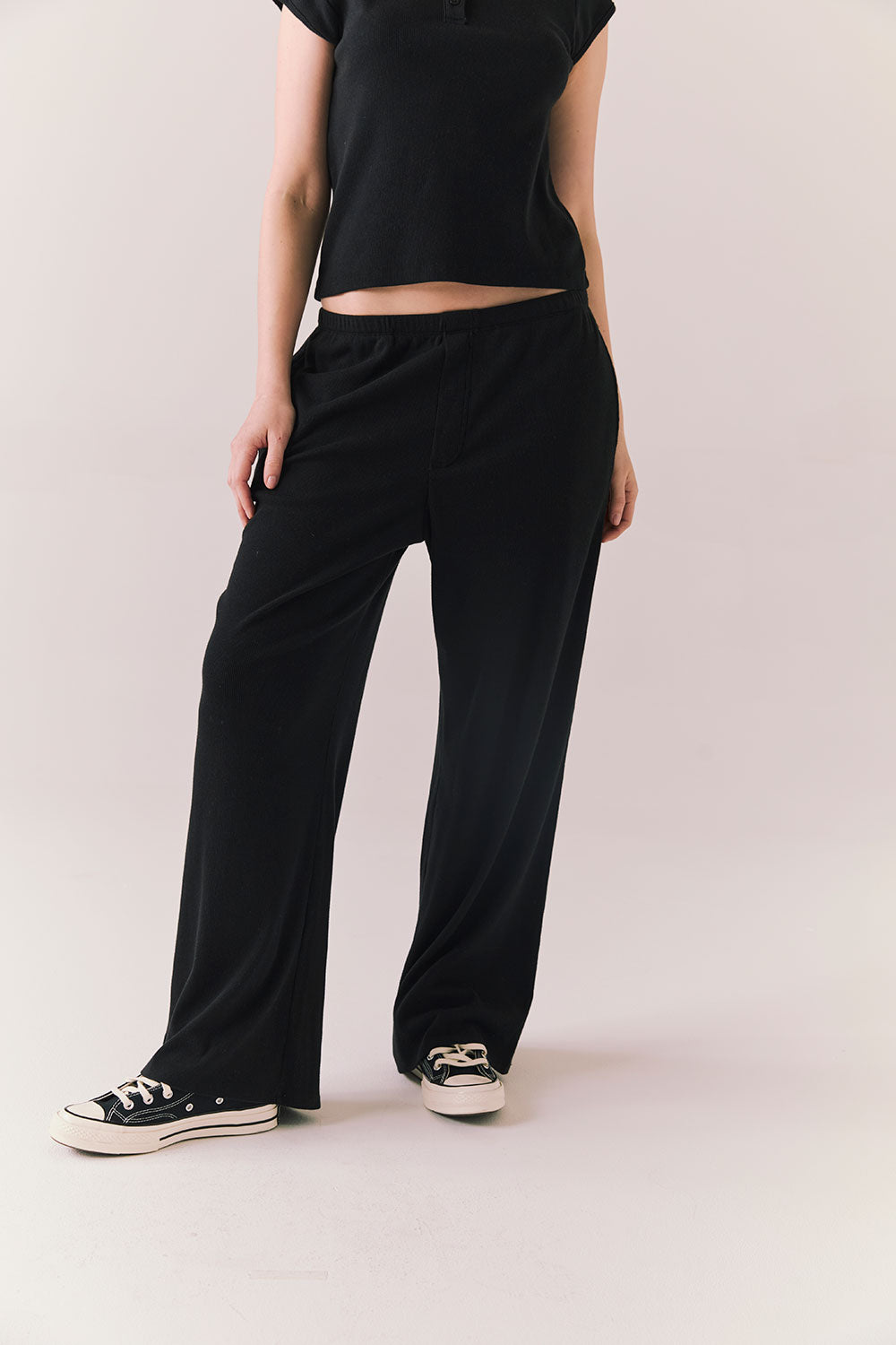True black fleece joggers with side pockets and relaxed silhouette.