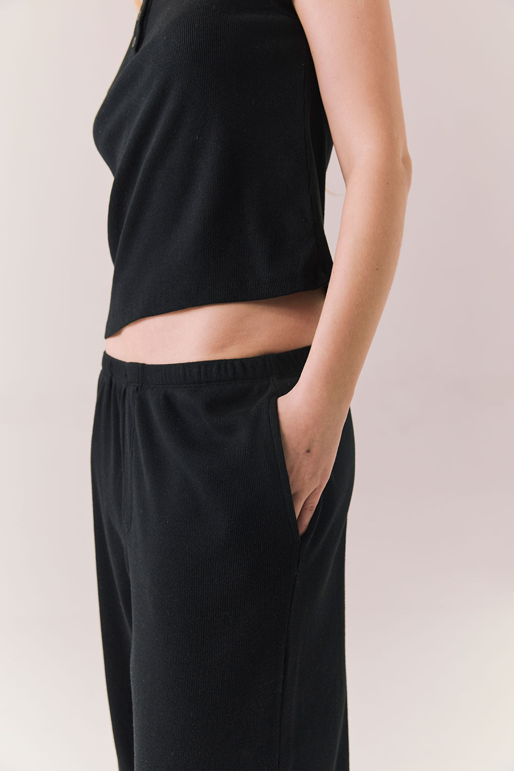 True black fleece joggers with side pockets and relaxed silhouette.