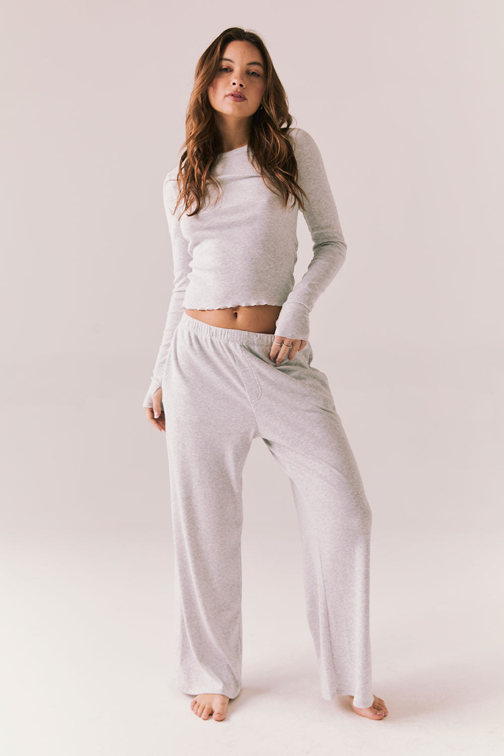 Light heather grey joggers with elastic waistband and relaxed fit, made from recycled fleece.
