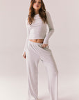 Light heather grey joggers with elastic waistband and relaxed fit, made from recycled fleece.