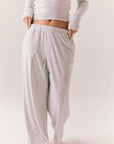 Light heather grey joggers with elastic waistband and relaxed fit, made from recycled fleece.