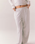 Light heather grey joggers with elastic waistband and relaxed fit, made from recycled fleece.