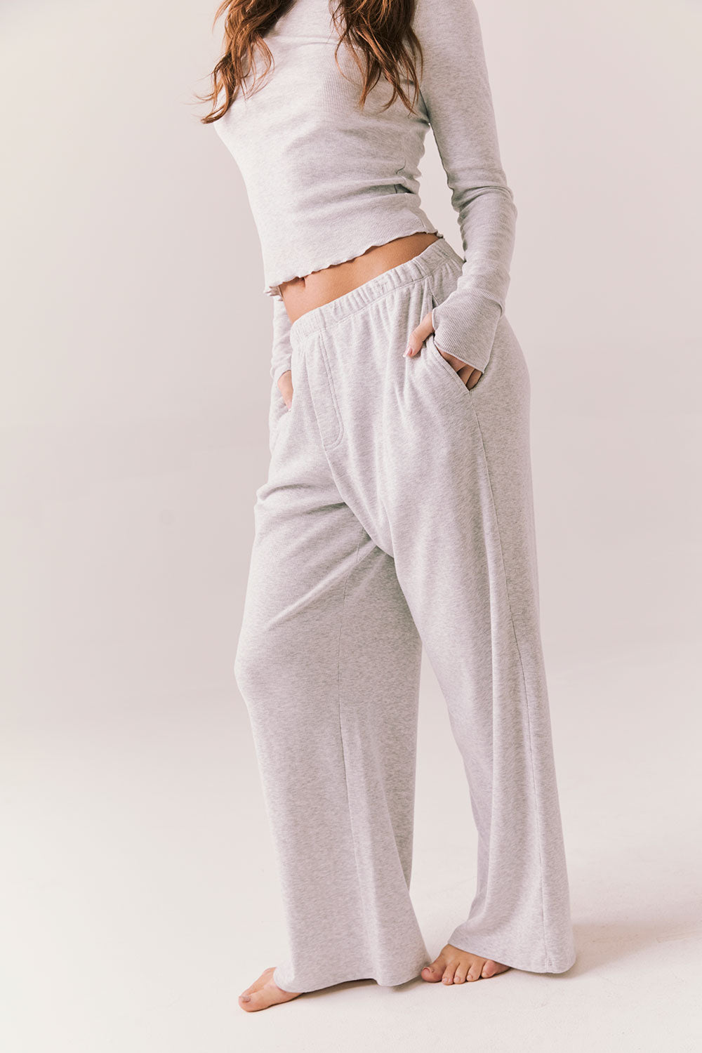 Light heather grey joggers with elastic waistband and relaxed fit, made from recycled fleece.