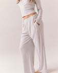 Light heather grey joggers with elastic waistband and relaxed fit, made from recycled fleece.