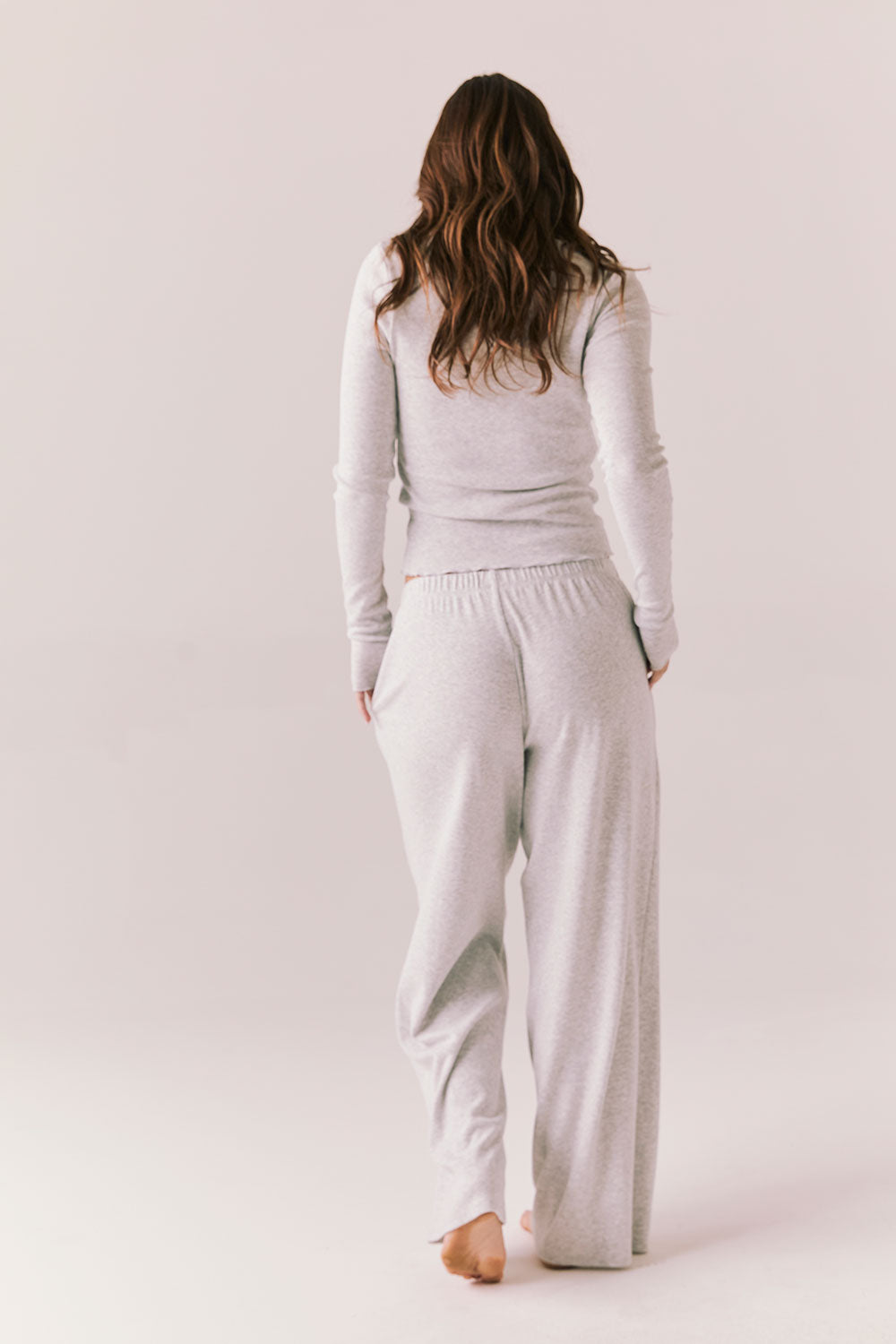 Light heather grey joggers with elastic waistband and relaxed fit, made from recycled fleece.