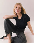 True black cropped tee with ruched side seams and high neck design.