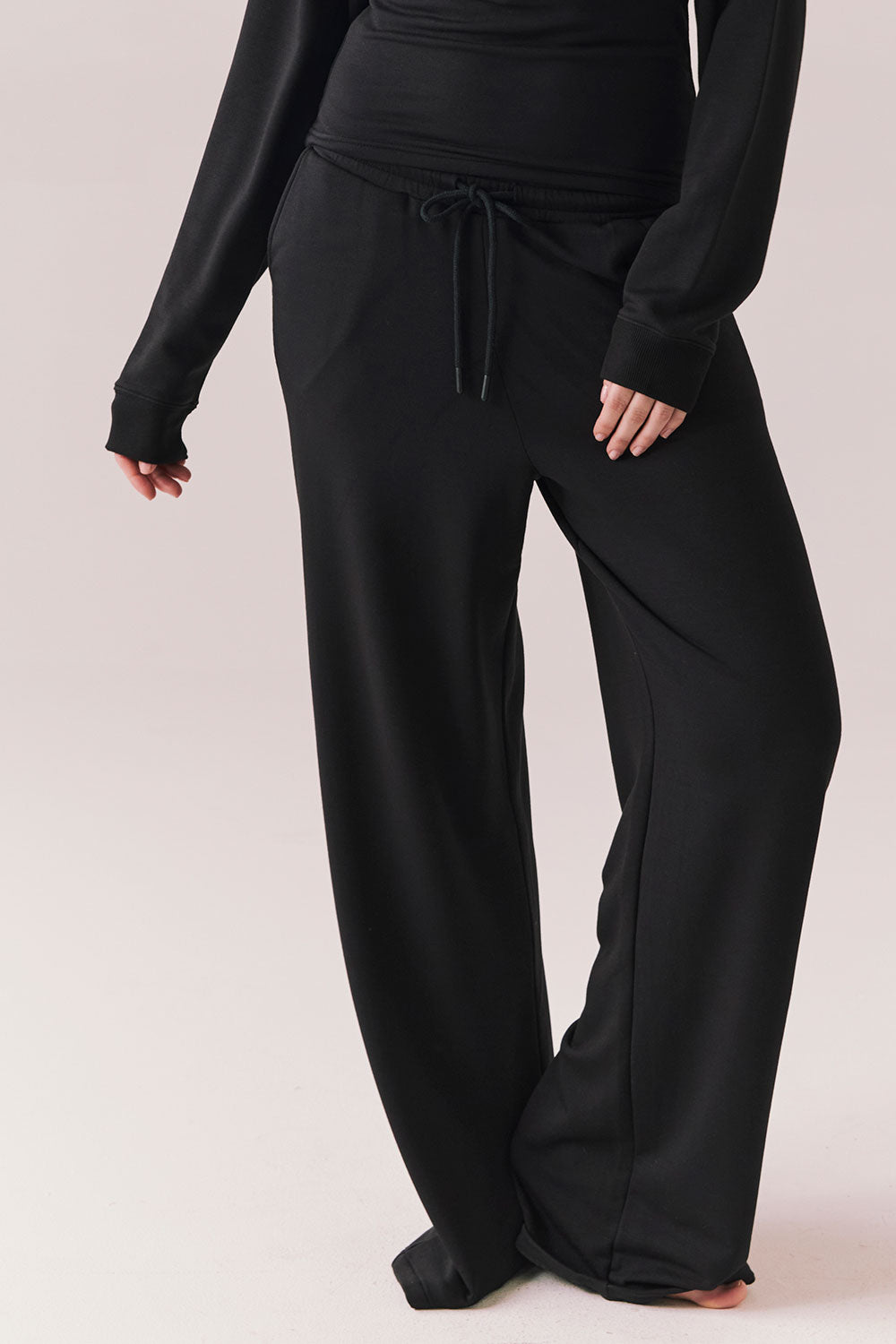 True black oversized lounge pants with wide leg fit and drawstring detail.