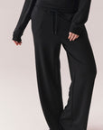 True black oversized lounge pants with wide leg fit and drawstring detail.