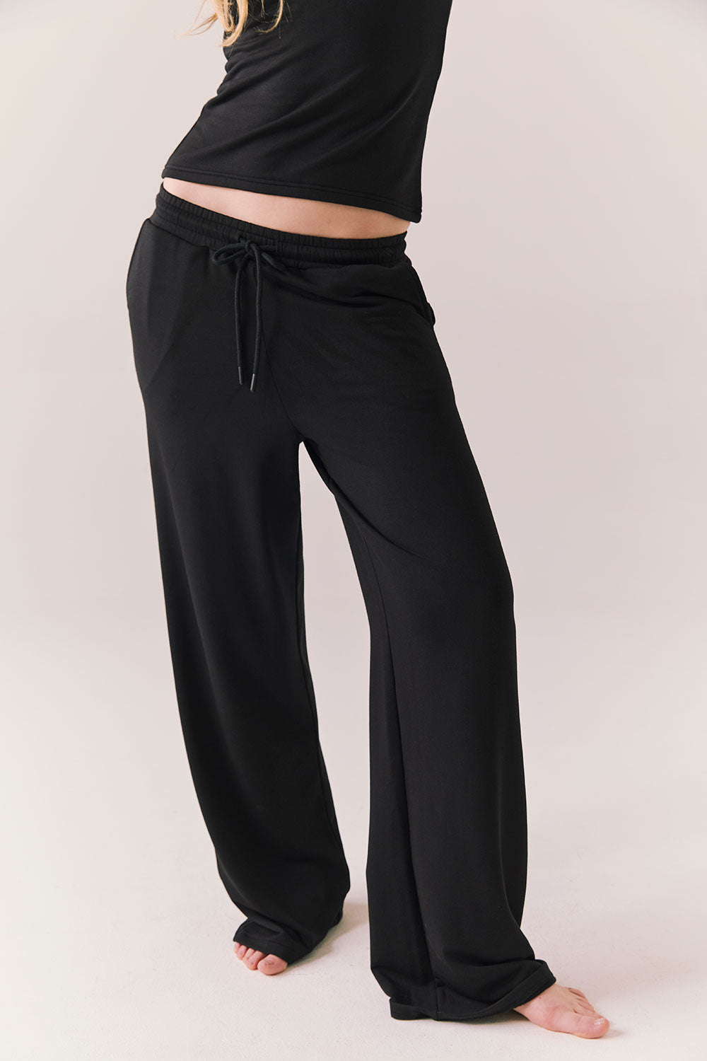 True black oversized lounge pants with wide leg fit and drawstring detail.
