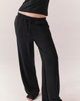 True black oversized lounge pants with wide leg fit and drawstring detail.