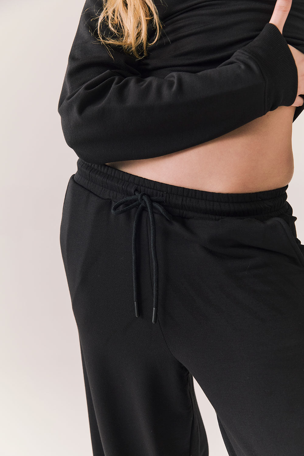 Closeup of black Sandyy trousers with modal blend texture and deep pockets.