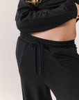Closeup of black Sandyy trousers with modal blend texture and deep pockets.