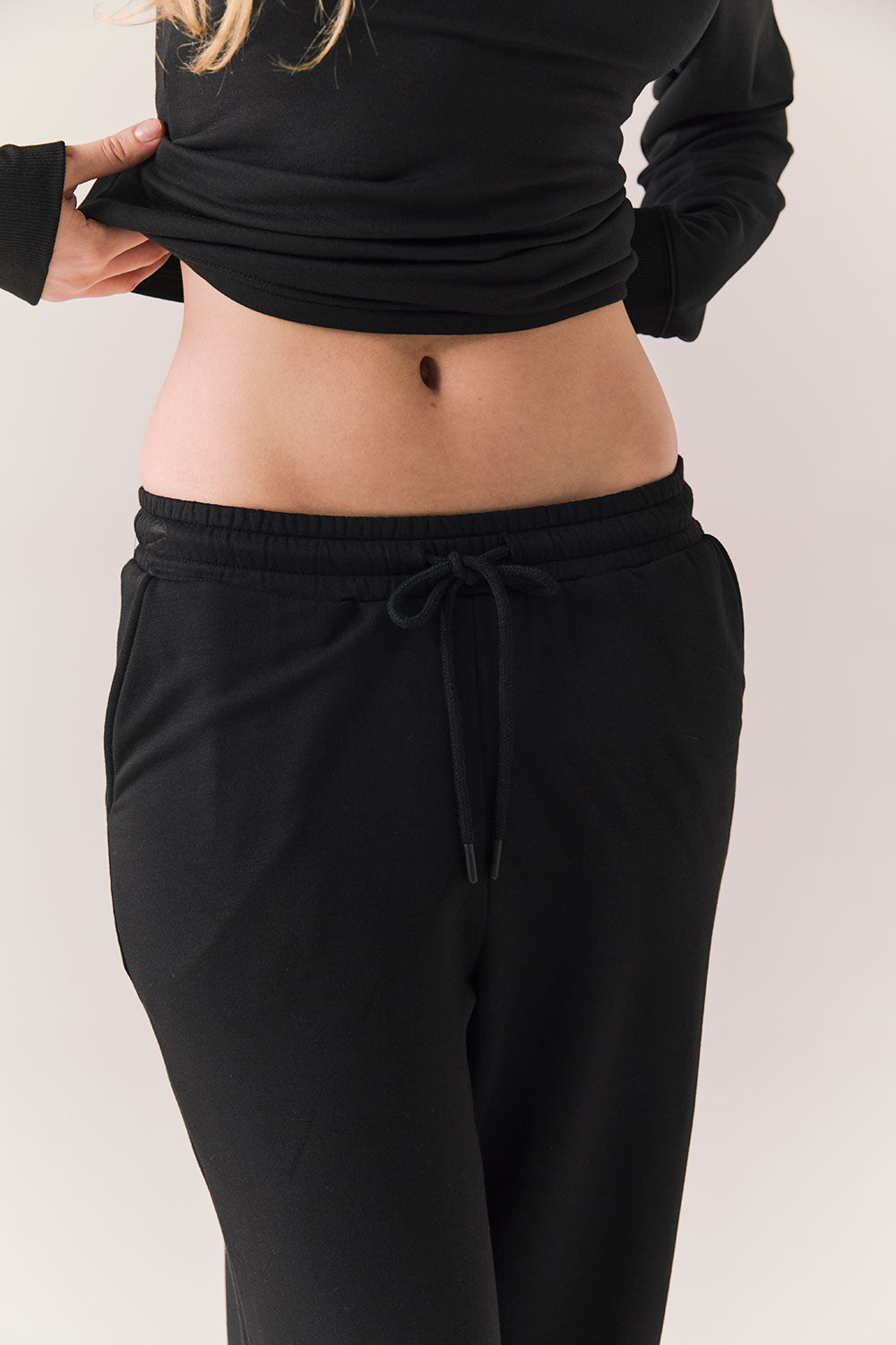 Closeup of True black oversized lounge pants with wide leg fit and drawstring detail.