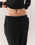 Closeup of True black oversized lounge pants with wide leg fit and drawstring detail.