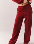 Crimson red lounge trousers with wide leg and relaxed fit front view.