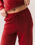 Crimson red lounge trousers with wide leg and relaxed fit closeup front view.