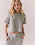 Front view of model in Irvine Tee in heather grey with soft thermal texture against a plain background