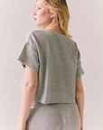 Back view of model in Irvine Tee in heather grey with soft thermal texture against a plain background