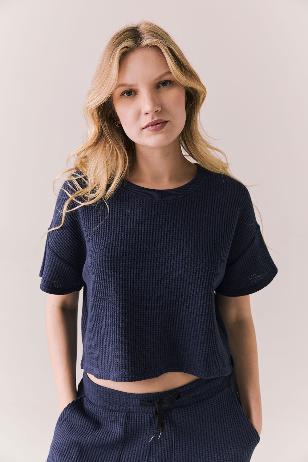 Front view of model in Irvine Tee in midnight blue with soft thermal texture on plain background
