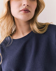 Front view of model in Irvine Tee in midnight blue with soft thermal texture on plain background